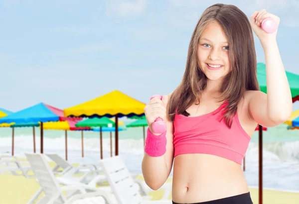 Girl and dumbbell — Stock Photo, Image