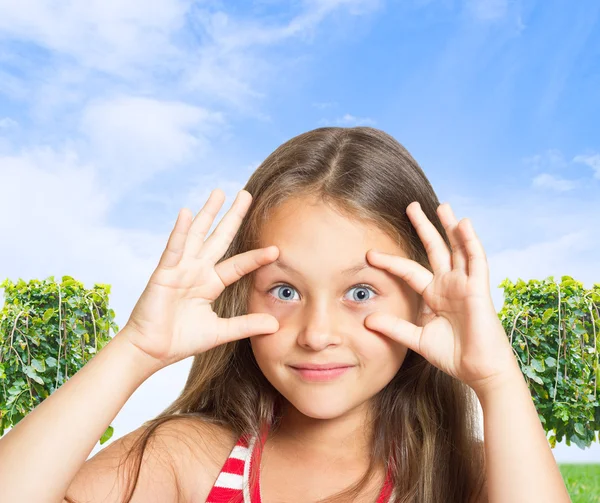 Funny girl on blue sky background — Stock Photo, Image