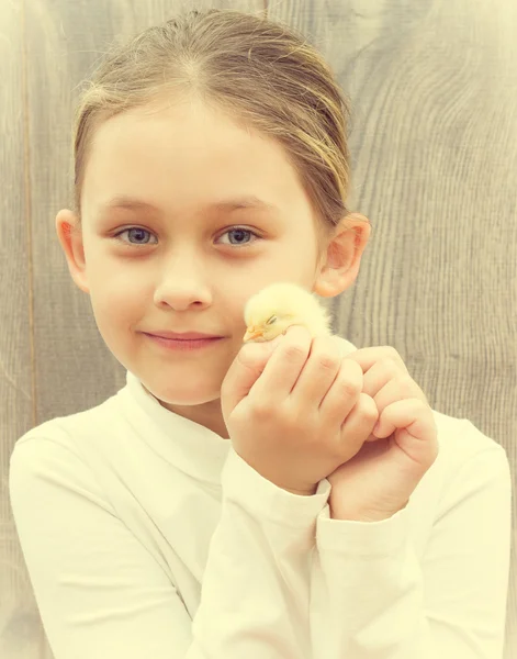 Cute little girl and yellow chicken Royalty Free Stock Photos