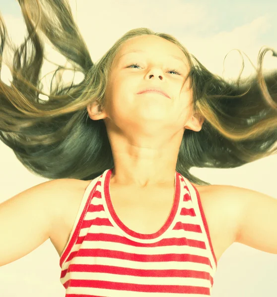 Lovely girl with flying long hair in the wind — Stock Photo, Image