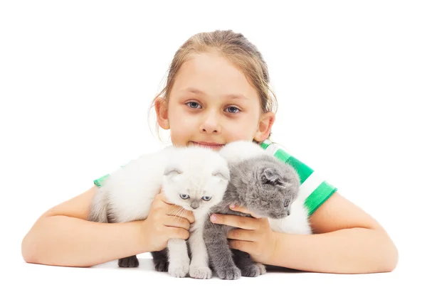 Kid embraces three British lop-eared kitten on a white backgroun Royalty Free Stock Photos