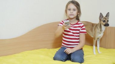 Uzaktan kumanda ve köpek ile kız