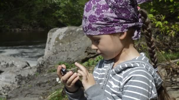 Girl playing with her smartphone — Stock Video