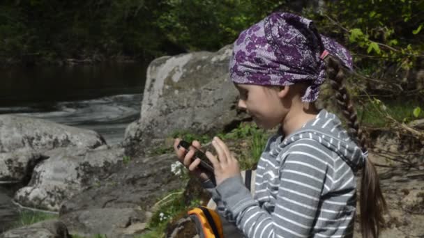 Girl playing with her smartphone — Stock Video