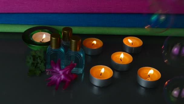 Aroma oils or perfume bottles with candles — Stock Video