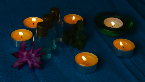 Aroma oils or perfume bottles with candles — Stock Video
