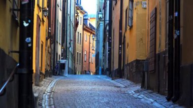 Stockholm 'ün merkezinde eski dar bir sokak. Eski kasaba. Mimarlık, eski evler, sokaklar ve mahalleler. İsveç. 4K 'da video, UHD
