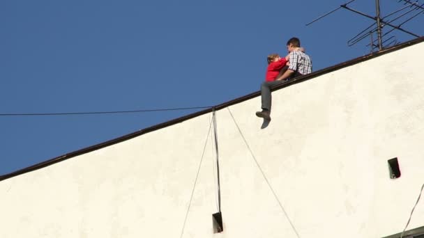 Couple embracing on roof of the house — Stock Video