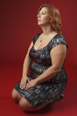 Kneeling woman  in cocktail dress