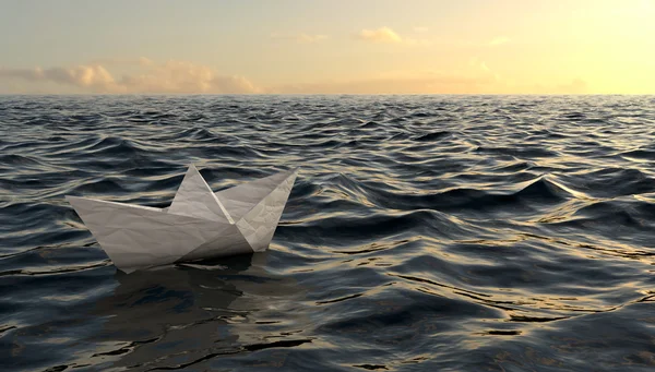 青い水にセーリング折り紙紙の船 ロイヤリティフリーのストック画像