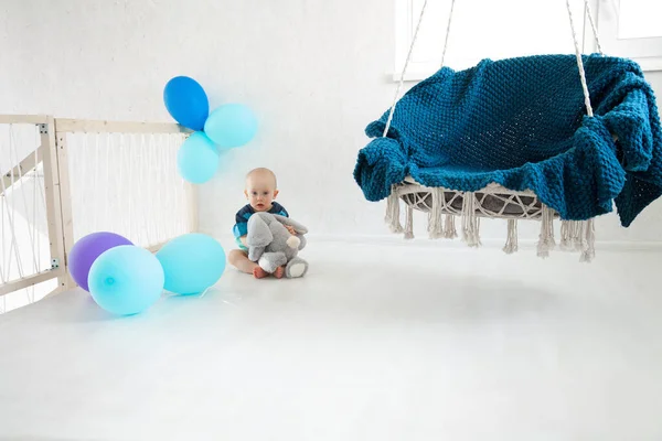 Little Boy Sits Floor Soft Toy Balloons Hanging Chair First — Stock Photo, Image