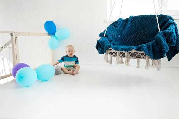 Little Boy Sits Floor Soft Toy Balloons Hanging Chair First — Stock Photo, Image
