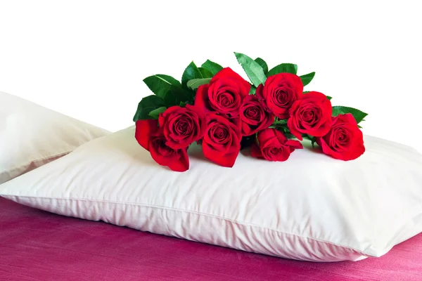 Red roses on a white pillow — Stock Photo, Image