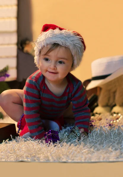 Baby in Santa hat with a small gifts — Stock Photo, Image