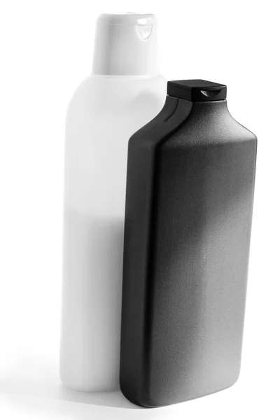 Witte en zwarte plastic flessen met shampoo en masker voor haar — Stockfoto