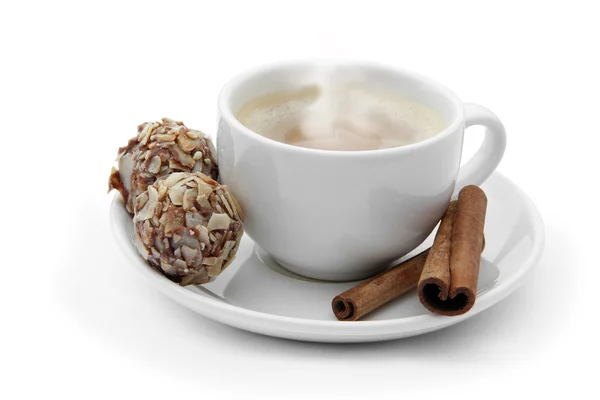 Cup of coffee with chocolate candies and cinnamon — Stock Photo, Image