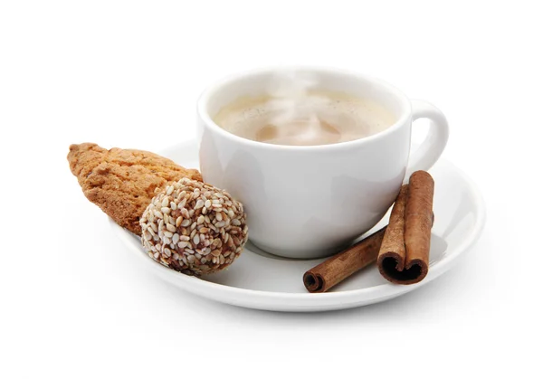 Cup of coffee with steam and chocolate candy, cookie and cinnamo — Stock Photo, Image
