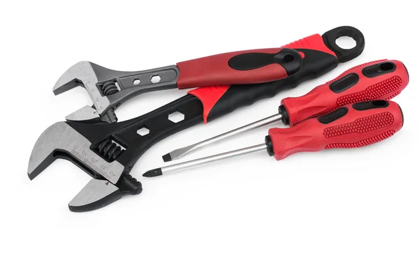 Red adjustable wrenches and screwdrivers — Stock Photo, Image