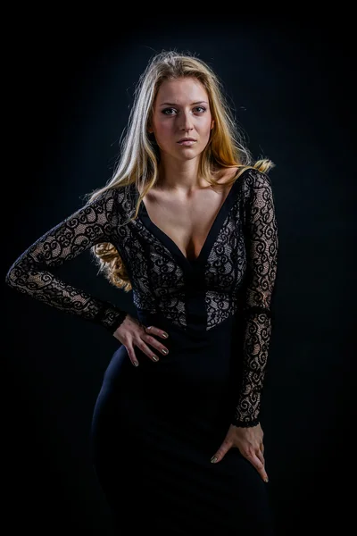 Blondýnka na černém pozadí v tmavé guipure šaty — Stock fotografie