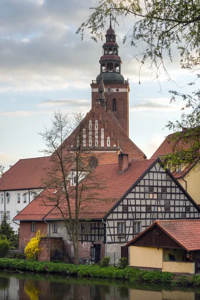 Old houses and church tower in Lidzbark Warminski — Stock Photo, Image