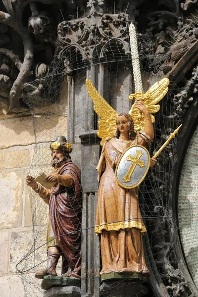 Statues of Angel and Philosopher at Prague astronomical clock — Stock Photo, Image
