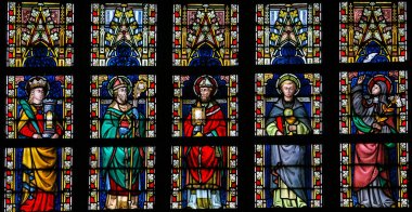 Stained glass window depicting Catholic Saints in Sint-Truiden C clipart