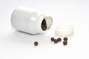 black pills of traditional medicine clipart