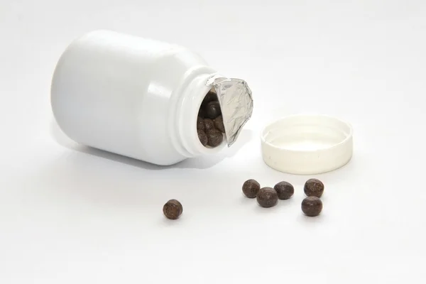 Black pills of traditional medicine — Stock Photo, Image