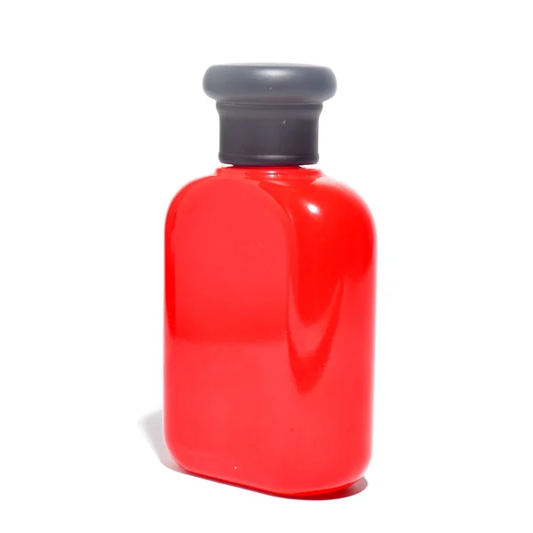 La bouteille emballage de couleur rouge isolé sur fond blanc — Photo