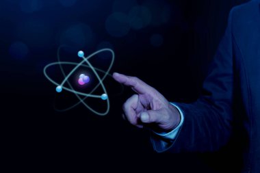 İşadamı mavi arka planda yaratıcı atomu tutuyor. Nükleer füzyon konsepti, sonsuz enerji, ucuz elektrik, gelecekteki teknolojiler. Bilim ve gelecek kavramı