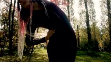 Güzel kız parkta jimnastik yapıyor. Sonbahar ormanlarında sağlık, sakinlik ve farkındalık, meditasyon, esnek vücut. aktif yaşam tarzı konsepti. Plaj sezonuna hazırlanıyorum.