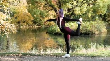 Güzel kız parkta jimnastik yapıyor. Fitness