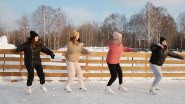 Women skaters are skating. Perform a group number. Rolling in a circle. Sunny weekend at the rink. Winter sports. Active lifestyle concept. female. Speed, virtuosity, professional — Wideo stockowe