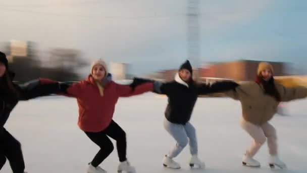 Women skaters are skating. Perform a group number. Rolling in a circle. Sunny weekend at the rink. Winter sports. Active lifestyle concept. female. Speed, virtuosity, professional — Wideo stockowe