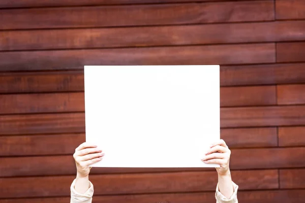 woman outside with a blank white card