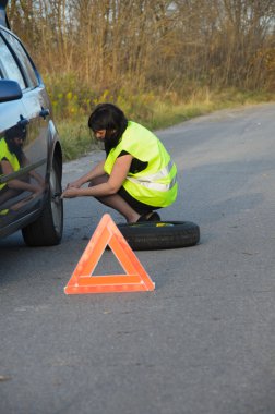 Kadın arabada tekerlekli değiştirme