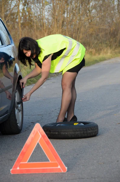 Kadın arabada tekerlekli değiştirme