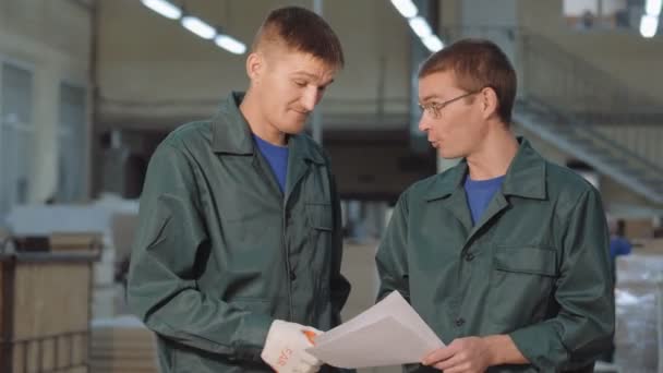 Engineers Discuss New Project. Workers in a warehouse, factory. Industrial plant. — стоковое видео