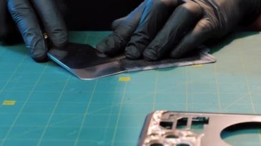 Deri işçisi. Deri kaplama. Deri işiyle uğraşan bir zanaatkar. Atölyedeki masada bir deri parçası var..