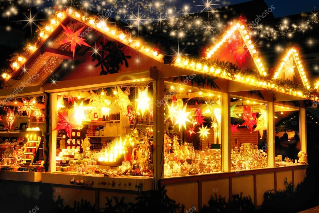 Illuminated Christmas fair kiosk with loads of shining decoration merchandise, no logos, with glittering magical stars raining down