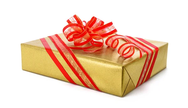 Isolated gold gift box with red bow Royalty Free Stock Photos