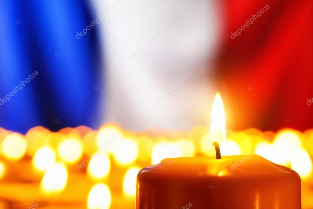 Candles in front of the France flag