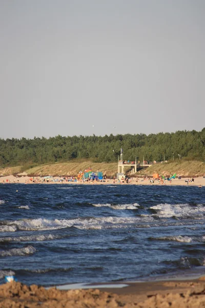 Plaj güneş su hava deniz kum dalgaları insanları tatil sunbather gökyüzü