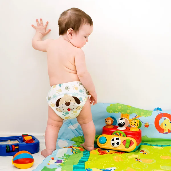 De jongen is terug naar de muur en draait — Stockfoto