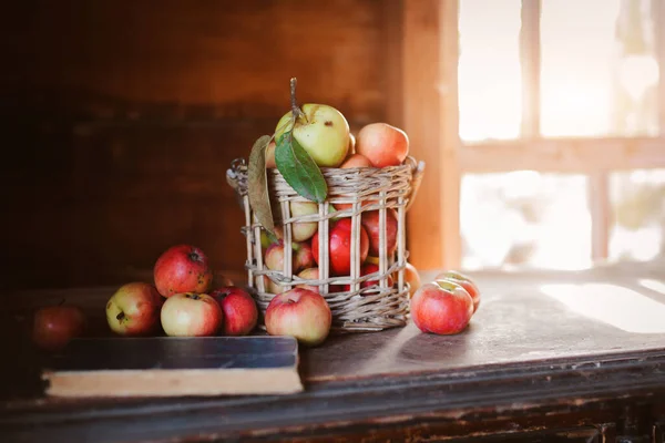 Fresh harvest of ripe and healthy farm apples in a glass jar, in a basket. — Stock Photo, Image