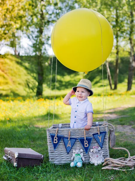 Little boy in a basket with  balloon — Stock Photo, Image