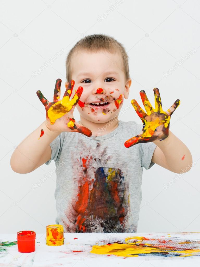 little boy playing with paints