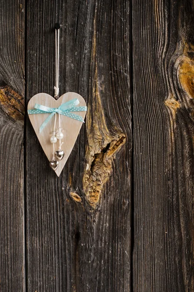 Wooden heart hanging on a branch — Stock Photo, Image