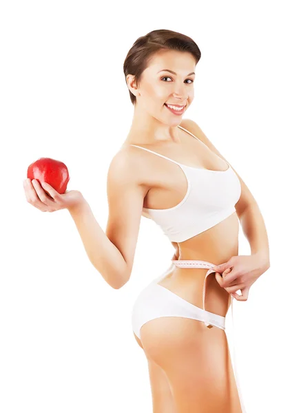 Flicka i vitt med mått och rött äpple — Stockfoto