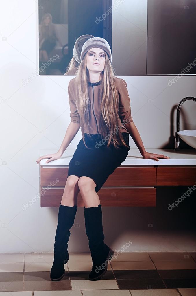 Woman sits on washstand